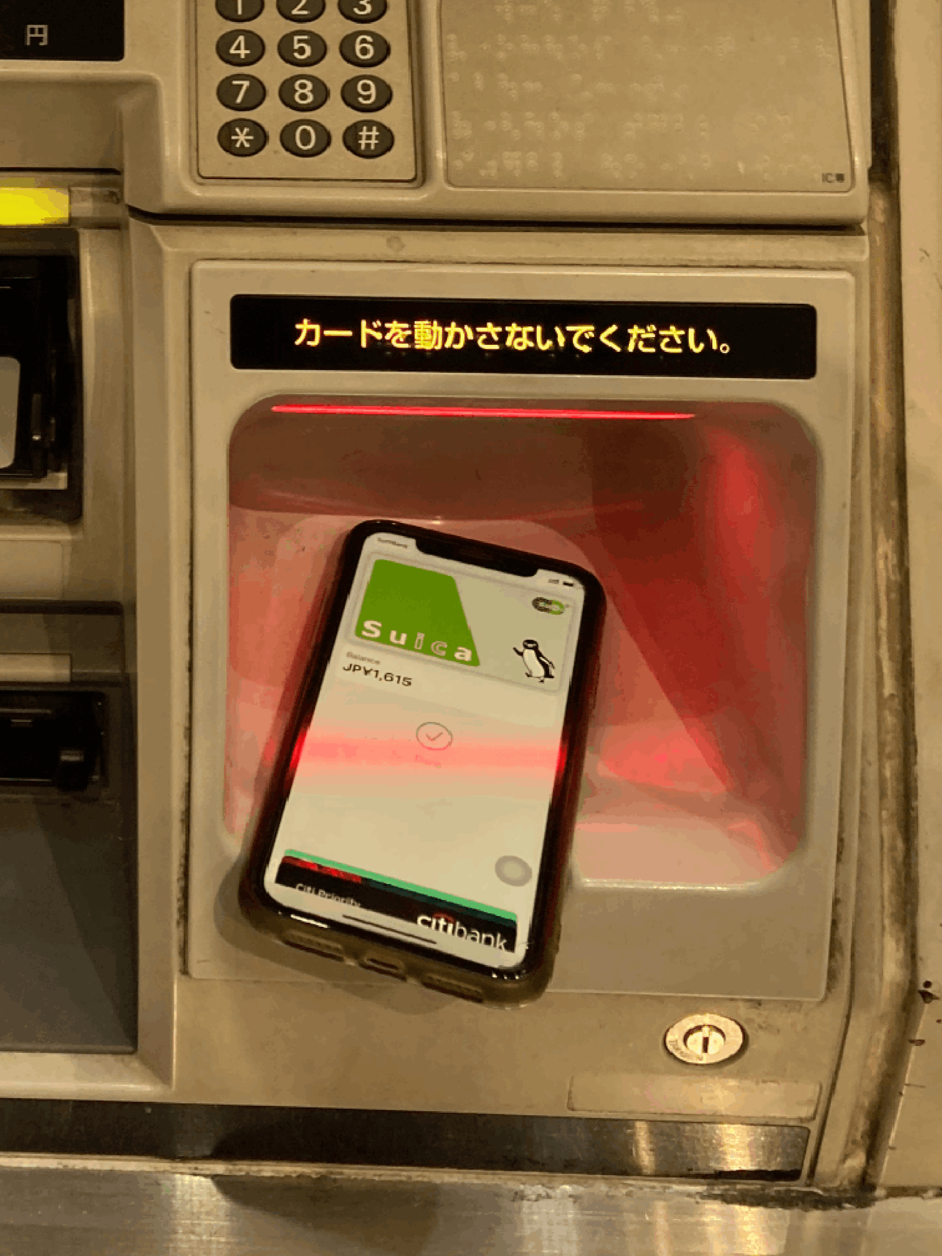 然後打開手機 Apple Wallet 的 Suica 卡,並將手機放入機器圖示的感應位置